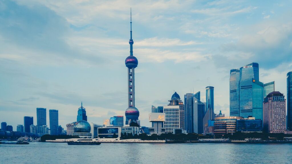 View of the Shanghai skyline with the iconic Oriental Pearl Tower on a clear day.